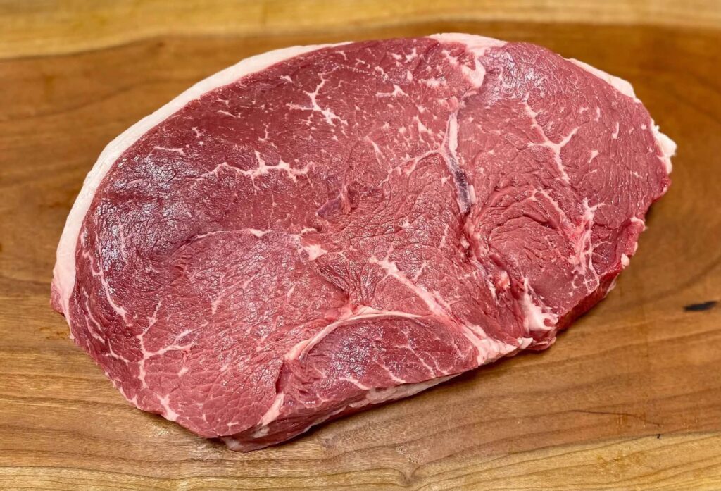 USDA Choice sirloin steak on a wooden cutting board at Lil Butcher Shoppe