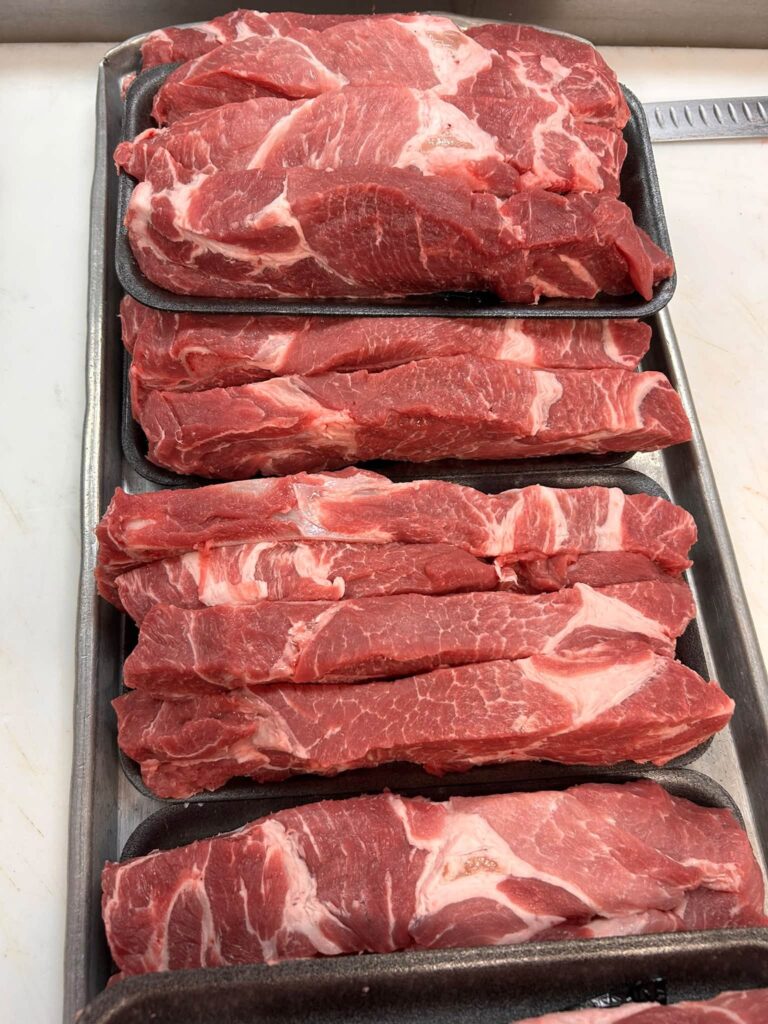 Trays of western style ribs in the Lil Butcher Shoppe meat case